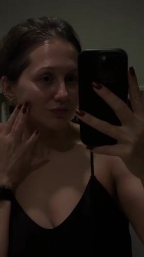 Woman documents skincare routine in Dubai bathroom selfie video
