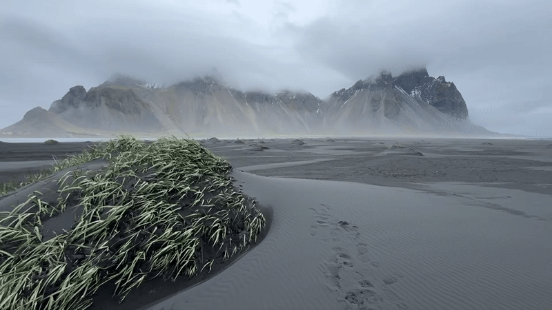 Tourist visits Iceland's black sand beach under cloudy skies