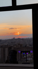 Sunset captured over Yerevan from elevated indoor vantage point