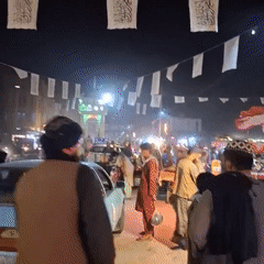 Sar-e Pol streets lit up at night with signs and activity