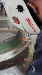 Welder works on curved metal piece in Barcelona