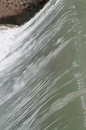 Water flows over small dam in Keudekrueng, Indonesia
