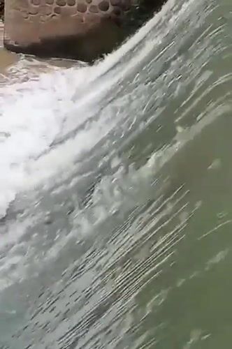 Water flows over small dam in Keudekrueng, Indonesia