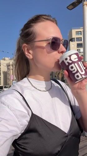 Casual street scenes documented in Bat Yam featuring woman, mirrored sphere