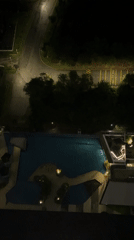 Nighttime aerial view of illuminated pool captured from Kuala Lumpur high-rise