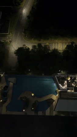 Nighttime aerial view of illuminated pool captured from Kuala Lumpur high-rise