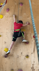 Boy rock climbing at indoor facility in Izhevsk, Russia