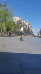 Skateboarder practices tricks in Barcelona public square