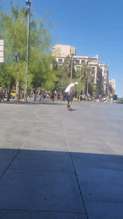 Skateboarder practices tricks in Barcelona public square
