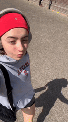 Woman in Harvard hoodie documented across Hull locations