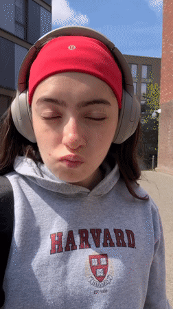 Woman in Harvard hoodie documented across Hull locations