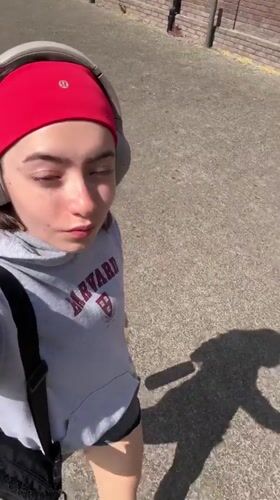 Woman in Harvard hoodie documented across Hull locations