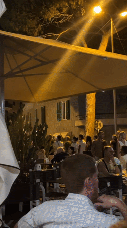 Live music and cafe tables on a summer night in Ospedaletti