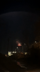 Person films fireworks display from street level in Sochi