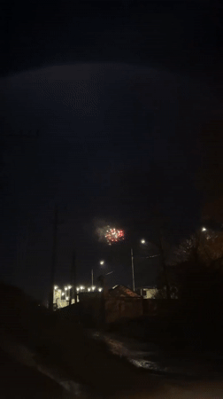 Person films fireworks display from street level in Sochi