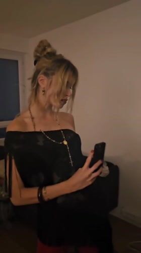 Woman checks smartphone in Pantin apartment Friday evening