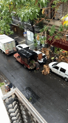 Commercial vehicles unloaded goods on rainy Buenos Aires street