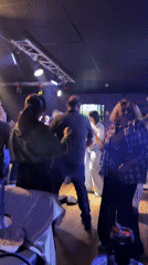 Group observed dancing at dimly lit club venue