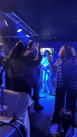 Group observed dancing at dimly lit club venue