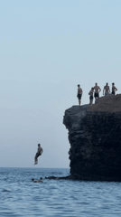 Cliff jumping into the Adriatic at Budva's rocky coastline