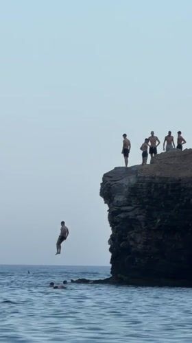 Cliff jumping into the Adriatic at Budva's rocky coastline