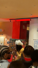 Art gallery gathering features speaker addressing attendees in London