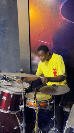 Drummer practices late night in Onitsha music studio
