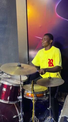 Drummer practices late night in Onitsha music studio