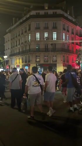Bastille Day crowds celebrate on a Paris street at night