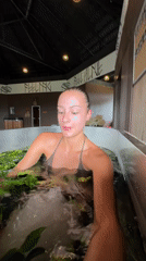 Woman receives ice-water plant therapy at Thai spa