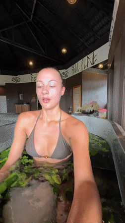 Woman receives ice-water plant therapy at Thai spa