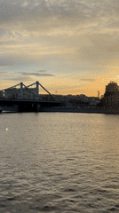 Tour boat travels Moscow river during golden sunset hour