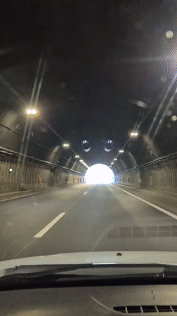 Vehicle crosses tunnel and bridge in Bulgarian mountains