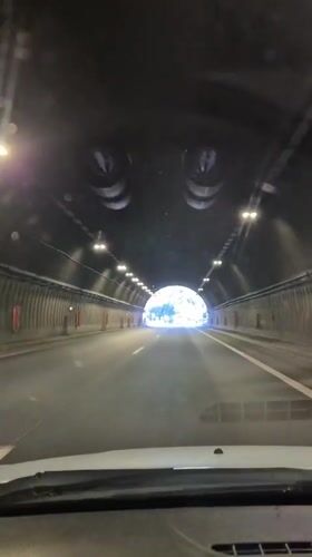 Vehicle crosses tunnel and bridge in Bulgarian mountains