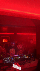 DJ performs afternoon set at red-lit Hangzhou nightclub