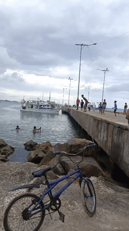 Evening beach gathering documented at Juan Griego pier, Venezuela