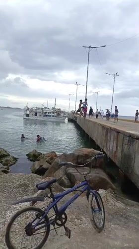 Evening beach gathering documented at Juan Griego pier, Venezuela