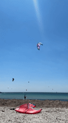 Kitesurfers hit the beach at Moudros on a clear morning
