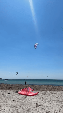 Kitesurfers hit the beach at Moudros on a clear morning