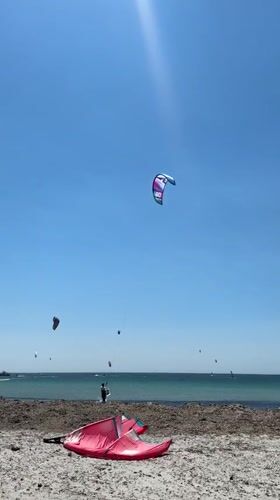 Kitesurfers hit the beach at Moudros on a clear morning