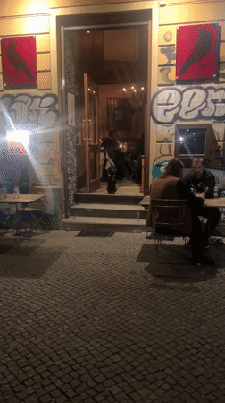 Berlin diner enjoys oysters at graffitied restaurant Friday evening