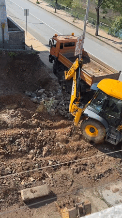 JCB backhoe conducts demolition work in Zlatograd, Bulgaria