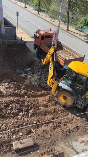 JCB backhoe conducts demolition work in Zlatograd, Bulgaria