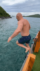 Jumping into the ocean off a turf-decked boat near Nha Trang