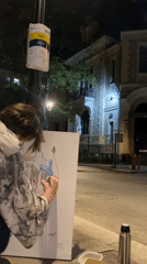 Nighttime street artist sketches on Moscow sidewalk