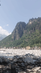 Milky glacial river rushes through Bahang village on a summer morning