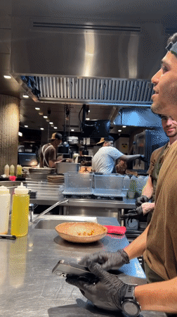 Chef with pink cloth observed in Madrid commercial kitchen