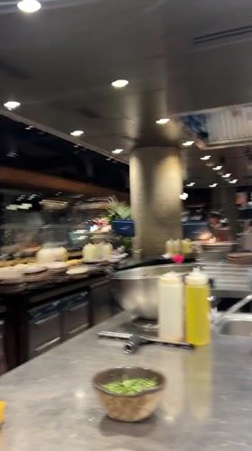 Chef with pink cloth observed in Madrid commercial kitchen