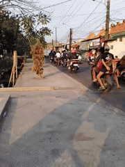 Morning street traffic and daily life in Belimbing, Indonesia