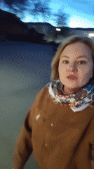Woman films evening walk with dog in Izhevsk